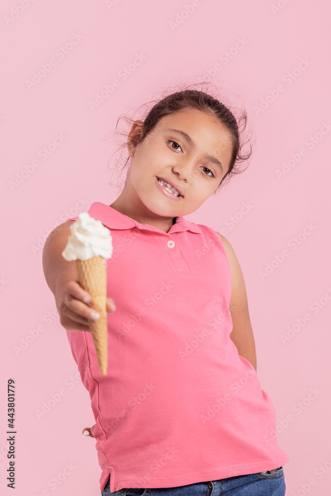 Generous little latina girl offering an ice cream cone at the camera Generous little latina girl offering an ice cream cone at the camera