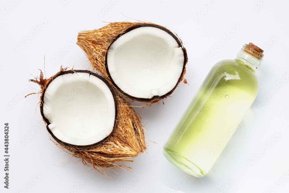 Coconut oil with coconuts on white background. Coconut oil with coconuts on white background.