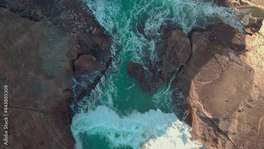 Waves washing over the rocky shoreline, Piha, New Zealand