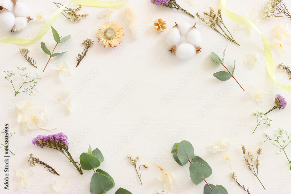 Top view image of flowers composition on white wooden background .Flat lay Top view image of flowers composition on white wooden background .Flat lay