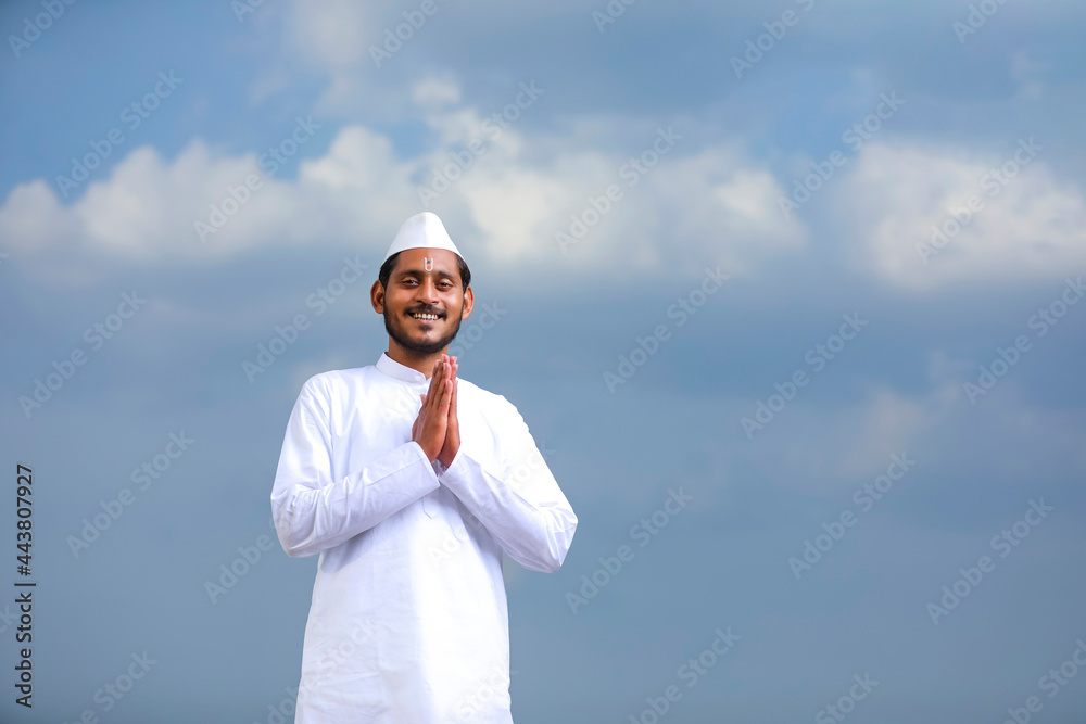 young indian man (pilgrim) in traditional wear and giving namaste or welcome gesture. young indian man (pilgrim) in traditional wear and giving namaste or welcome gesture.