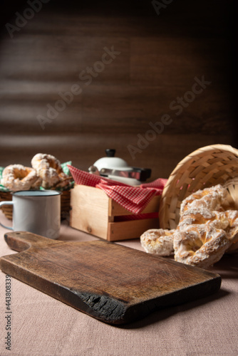 Brazilian sweet biscuit and a cup of coffee on a table with beige tablecloth, selective focus.