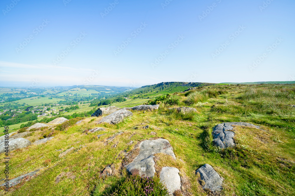 Many partially buried gritstone rocks litter the top of Baslow Edge