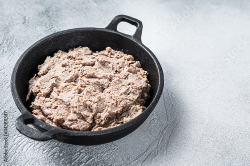 Duck Rillettes de Canard in a pan. White background. Top View.  Copy space © Vladimir