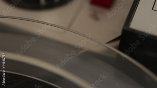 Close up of film tape at vintage reel to reel player. Reel to reel tape recorder playing. Retro tape. Popular Disco Trends 60s, 70s, 80s, 90s. Oldschool concept.