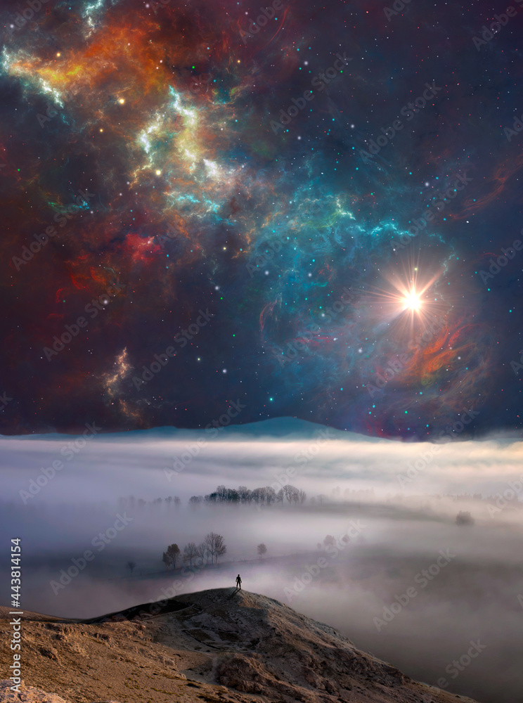 Man silhouette standing on rock with misty fog, distant hill, nebula and sun. Photo manipulation with digital painting