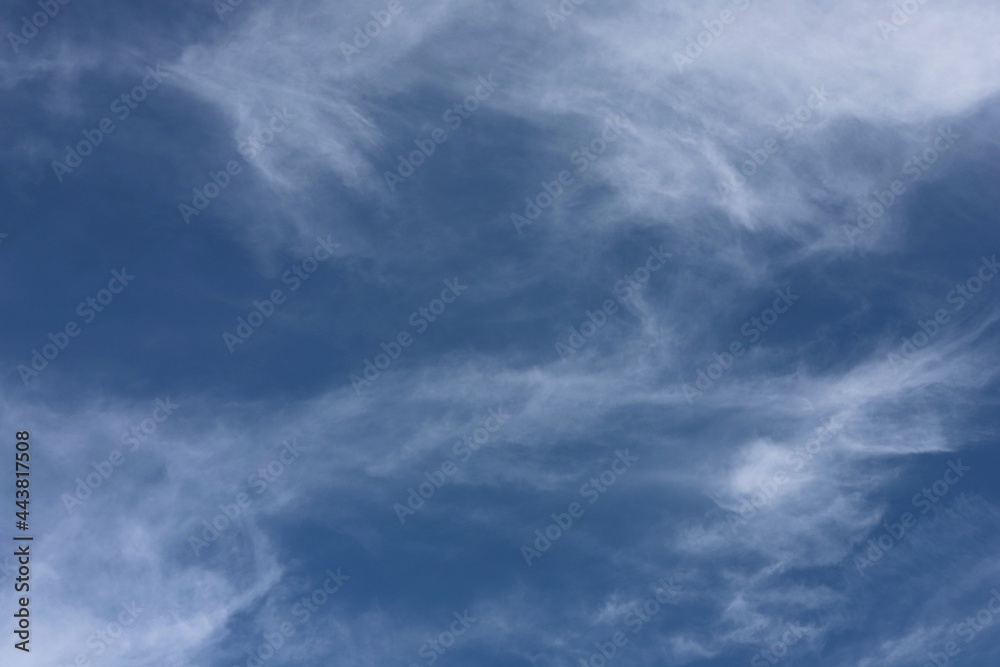 natural background blue sky with stretched stripes of clouds