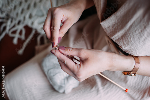 Women's hands are holding balls of yarn, wool Start knitting. Women's hobby.