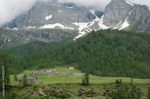 Lovely alpine landscape: village of Cianciavero in Alpe Veglia, dominated by the Monte Leone in the background, Alpe Veglia, Varzo, Province of Verbano Cusio Ossola, Piedmont, Alps, Italy photo