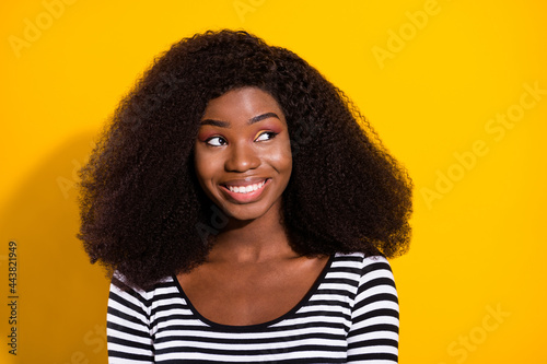 Photo portrait of young model curious dreamy looking copyspace isolated on vibrant yellow color background © deagreez