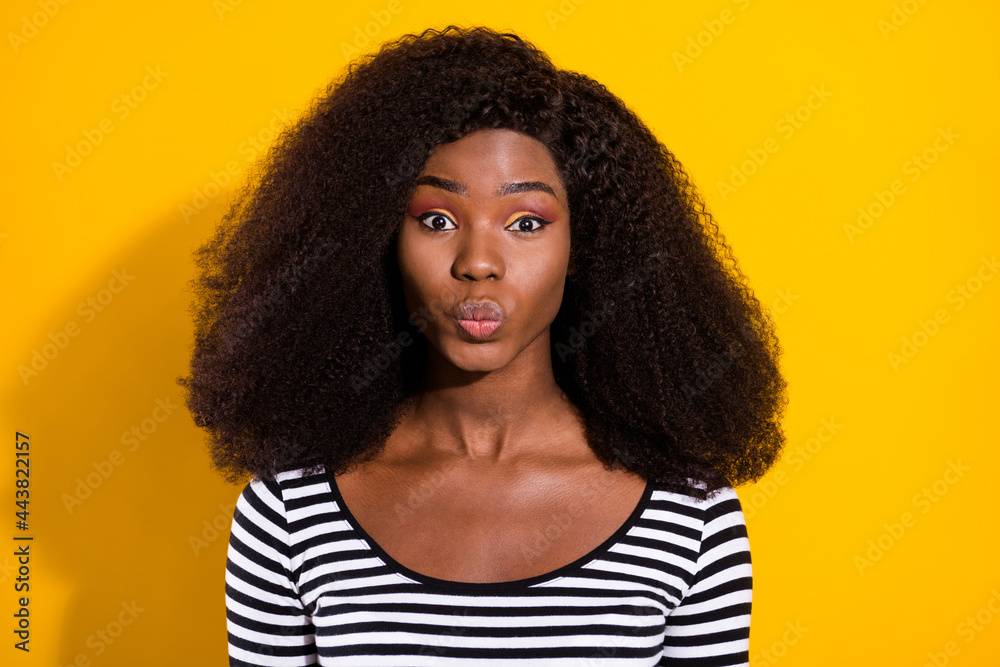 Photo portrait of young model sending air kiss with pouted lips isolated on vivid yellow color background Photo portrait of young model sending air kiss with pouted lips isolated on vivid yellow color background
