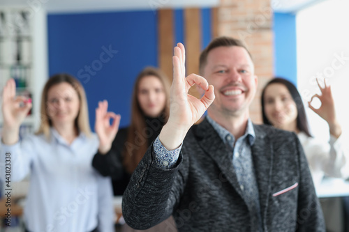 Group of business people showing hand gesture ok closeup