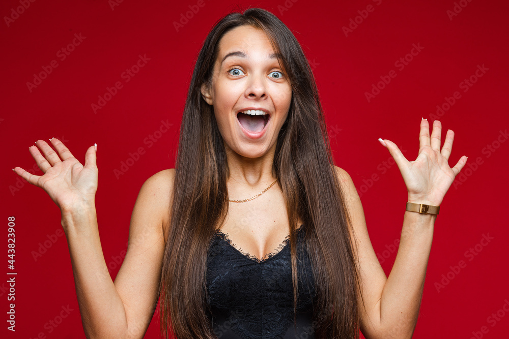 Excited woman reacting at something with raised arms. Excited woman reacting at something with raised arms.