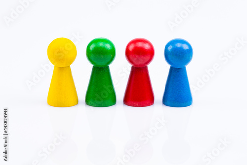 The photo shows different colored wooden figures isolated on white background © Ralf Kalytta