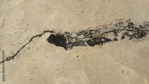 black paint on cracked concrete