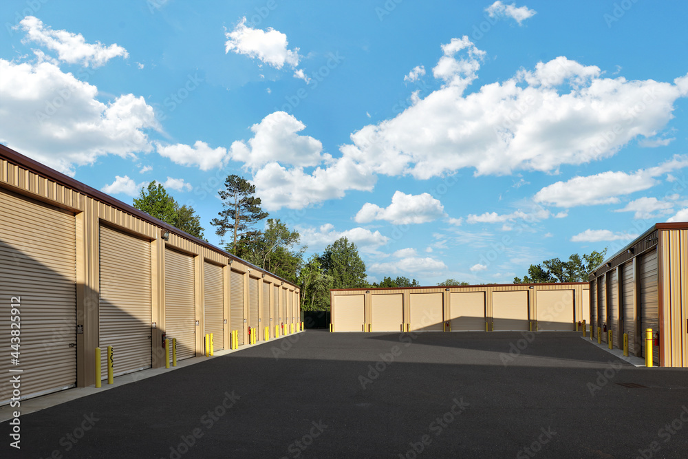 Large industrial storage warehouse complex with brown warehouse buildings under blue sky