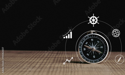 Photos Business navigate concept, compass navigation on table for guide to recovery business planning growth in the economic crisis and trading graph financial data, action plan icon