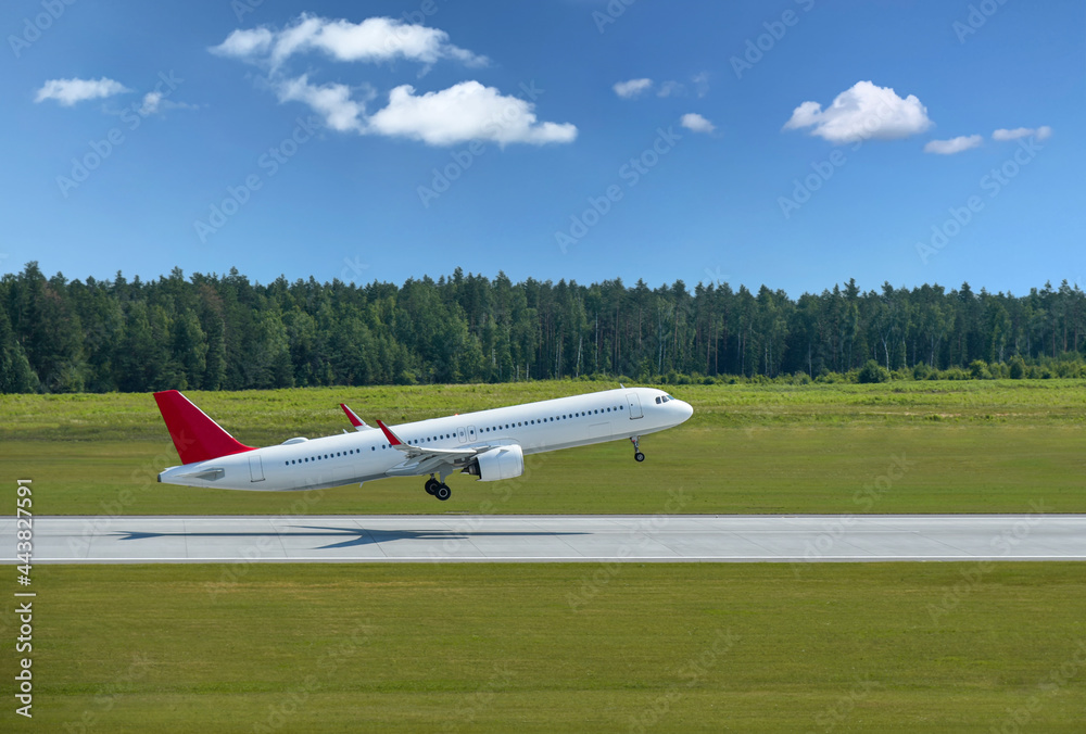 Passenger plane takes off from airport runway in forest Passenger plane takes off from airport runway in forest