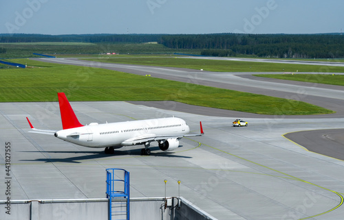 The car accompanies a passenger plane to the runway