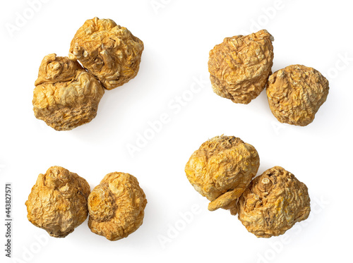 Two dried yellow Maca roots isolated on white background, top view photo