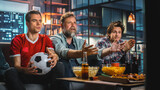 Night At Home: Three Joyful Soccer Fans on a Couch Watch Game on TV, Celebrate Victory when Sports Team Wins Championship. Friends Cheer for Favourite Football Club Play.