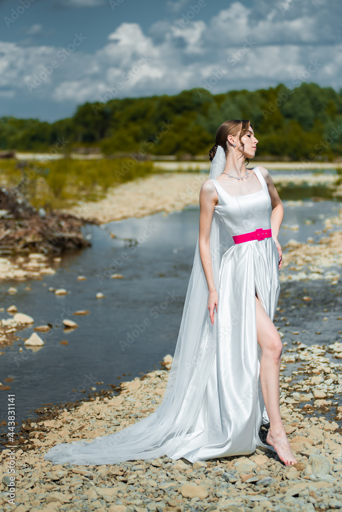 Young bride posing near the river