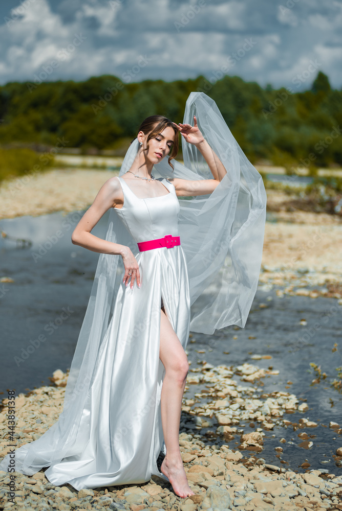 Fashion bride posing on mountain river. Wedding day