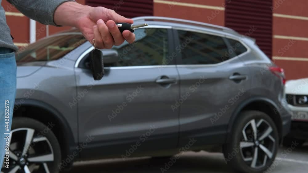 The man is holding the car keys. Car purchase, rental, insurance, car safety. The man is holding the car keys. Car purchase, rental, insurance, car safety.