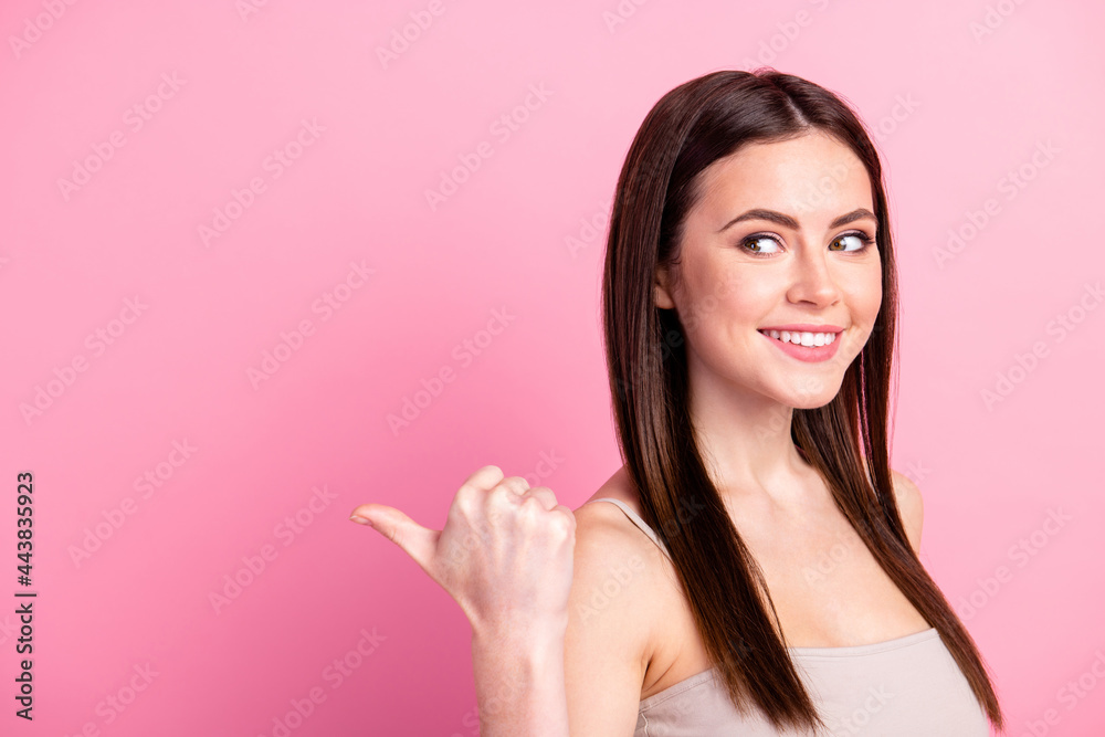 Photo of young attractive girl happy positive smile indicate thumb empty space ad promo advice sale isolated over pastel color background Photo of young attractive girl happy positive smile indicate thumb empty space ad promo advice sale isolated over pastel color background
