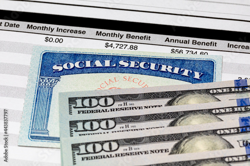 Social Security Card, benefits statement and 100 dollar bills. Social security funding, payment, retirement and federal government benefits concept photo