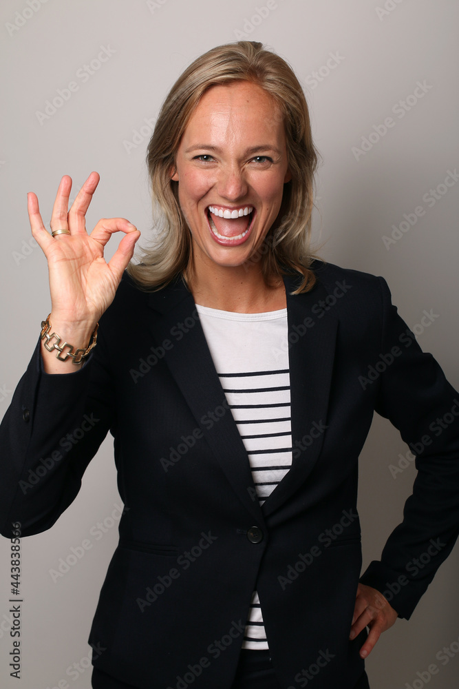 Beautiful happy commercial woman in front of a colored background Beautiful happy commercial woman in front of a colored background