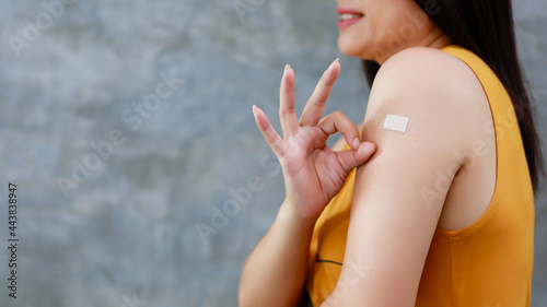 Asian woman shows confidence after getting vaccinated against covid-19 and looks confidently at the camera Concept of building immunity from epidemic.