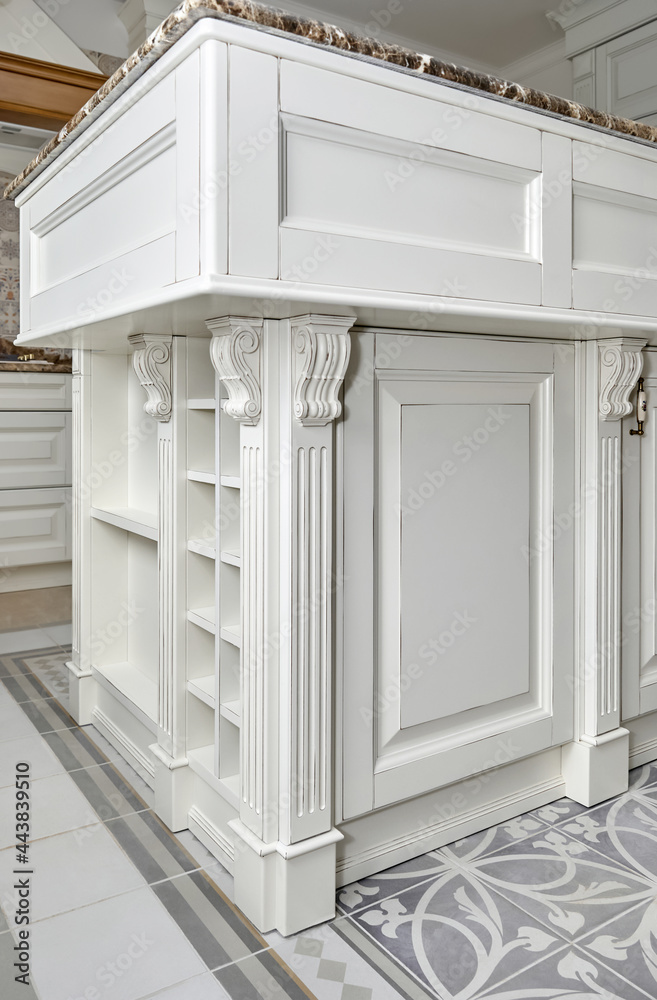 Fragment of kitchen island in country style with carved elements close-up Fragment of kitchen island in country style with carved elements close-up
