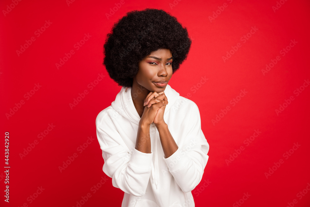 Photo of unsure brunette hair millennial lady hold hands wear white hoodie isolated on red color background Photo of unsure brunette hair millennial lady hold hands wear white hoodie isolated on red color background