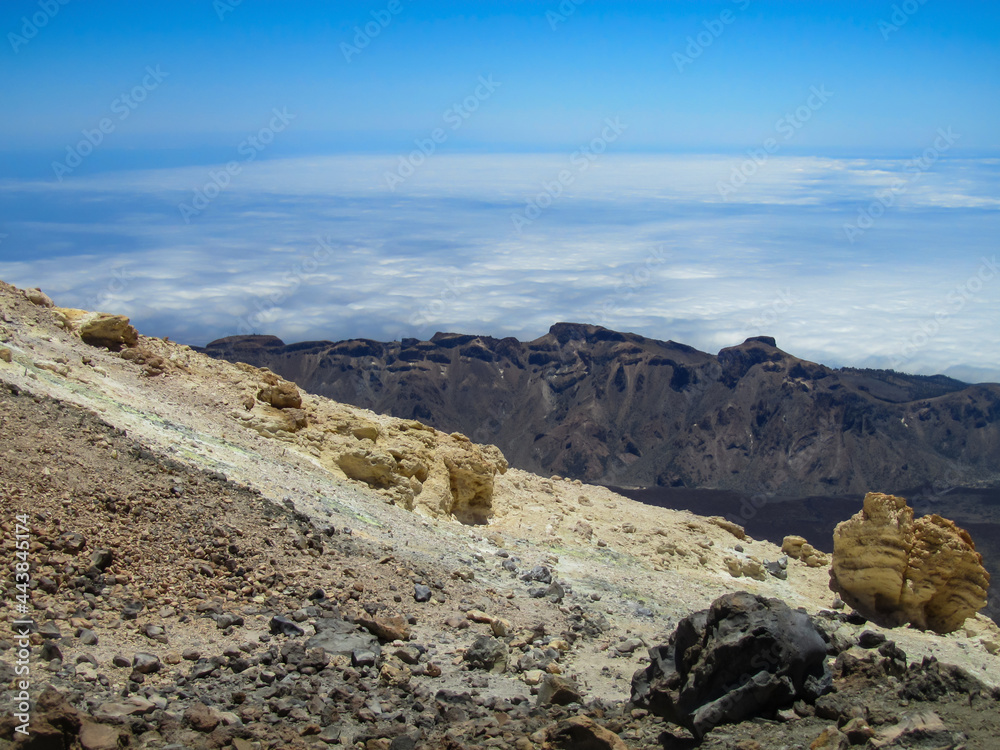 View from the slope of the volcano on the caldera and the layer of clouds below View from the slope of the volcano on the caldera and the layer of clouds below