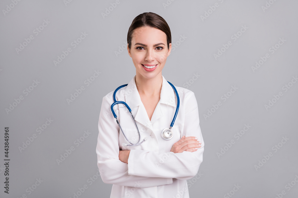Photo of confident charming young lady doctor workwear hands folded isolated grey color background Photo of confident charming young lady doctor workwear hands folded isolated grey color background