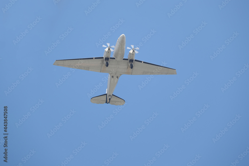 Fototapeta premium two-engine airplane fly over the camera shot