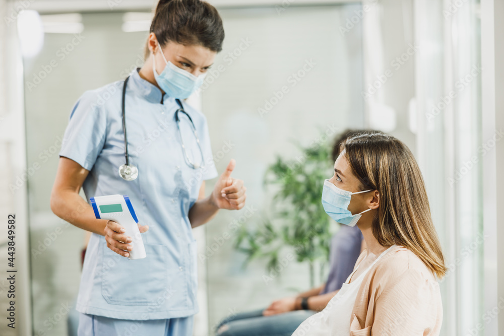 Nurse Measuring Temperature In Waiting Room Nurse Measuring Temperature In Waiting Room