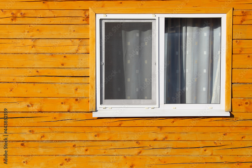 Fototapeta premium Double-glazed windows in a wooden house. Close-up. Background. Texture.