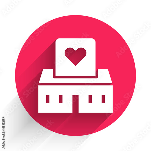 White Volunteer center icon isolated with long shadow. Red circle button. Vector