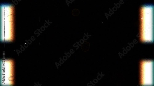 In front of the camera, old film passes from top to bottom, but it is spoiled and nothing is visible except interference.