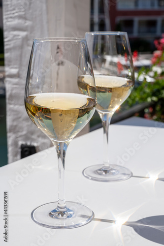 Summer on French Riviera Cote d'Azur, drinking cold dry white wine from Cotes de Provence on outdoor terrase in Port Grimaud, Var, France