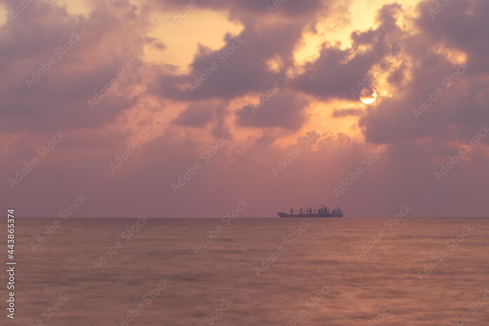 long exposure of a ship sailed on the horizon of the Sea of ashkelon, Israel. At sunset