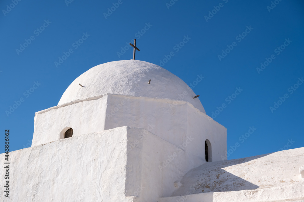 Folegandros island, Old church at Chora town against blue sky background. Greece, Cyclades.