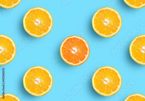 Orange fruit slice on soft pastel blue background. Lemon fruit, citrus minimal concept, vitamin C. Creative summer minimalistic background. Top view