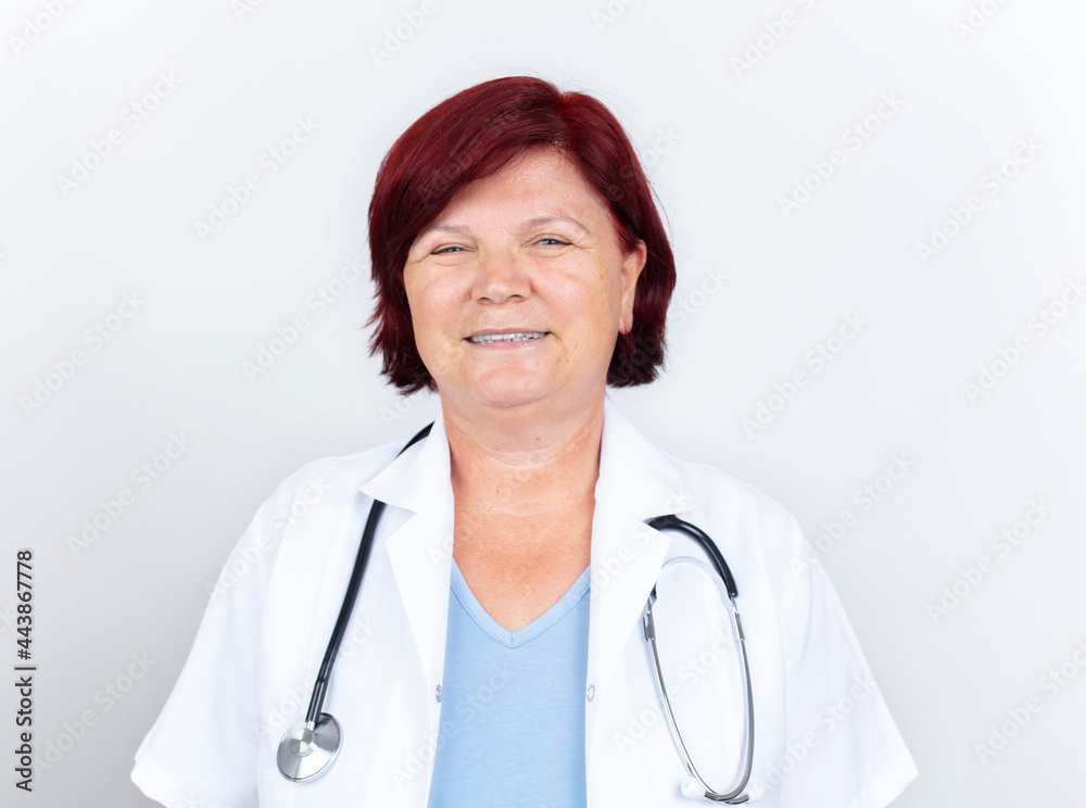 Fototapeta premium Senior female doctor. Portrait of beautiful mature female doctor looking at camera. Medical concept