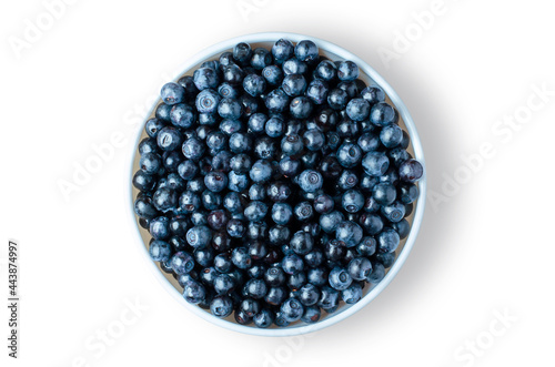 Blueberry. Ripe berries in a white plate. Isolated on white