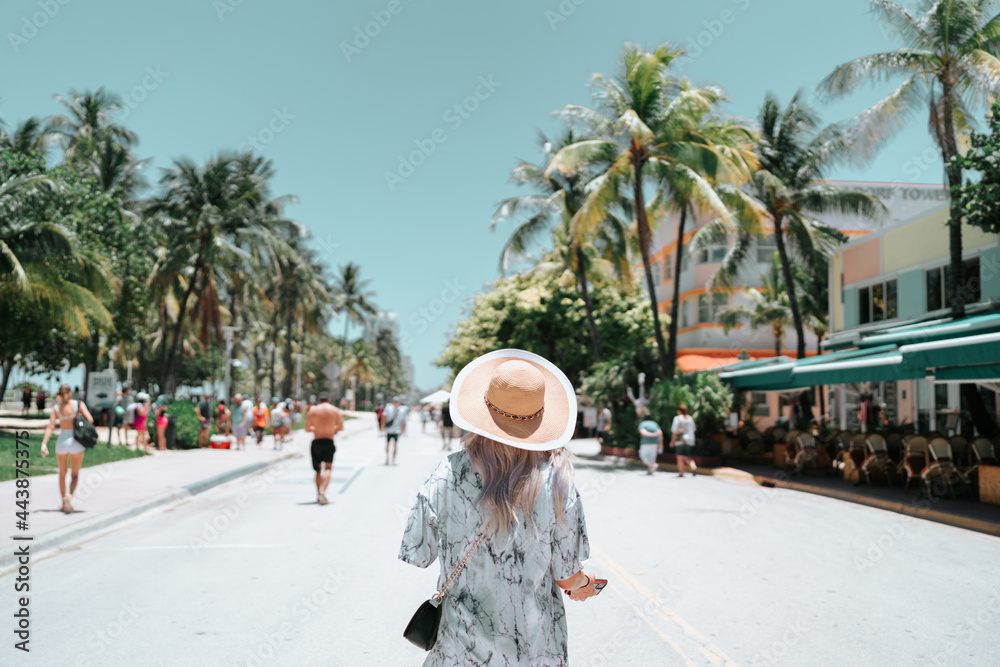 woman walking on the beach summer tropical palms Miami Florida 