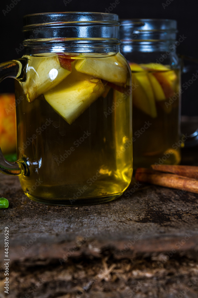 A refreshing jug of apple cider on wood table A refreshing jug of apple cider on wood table