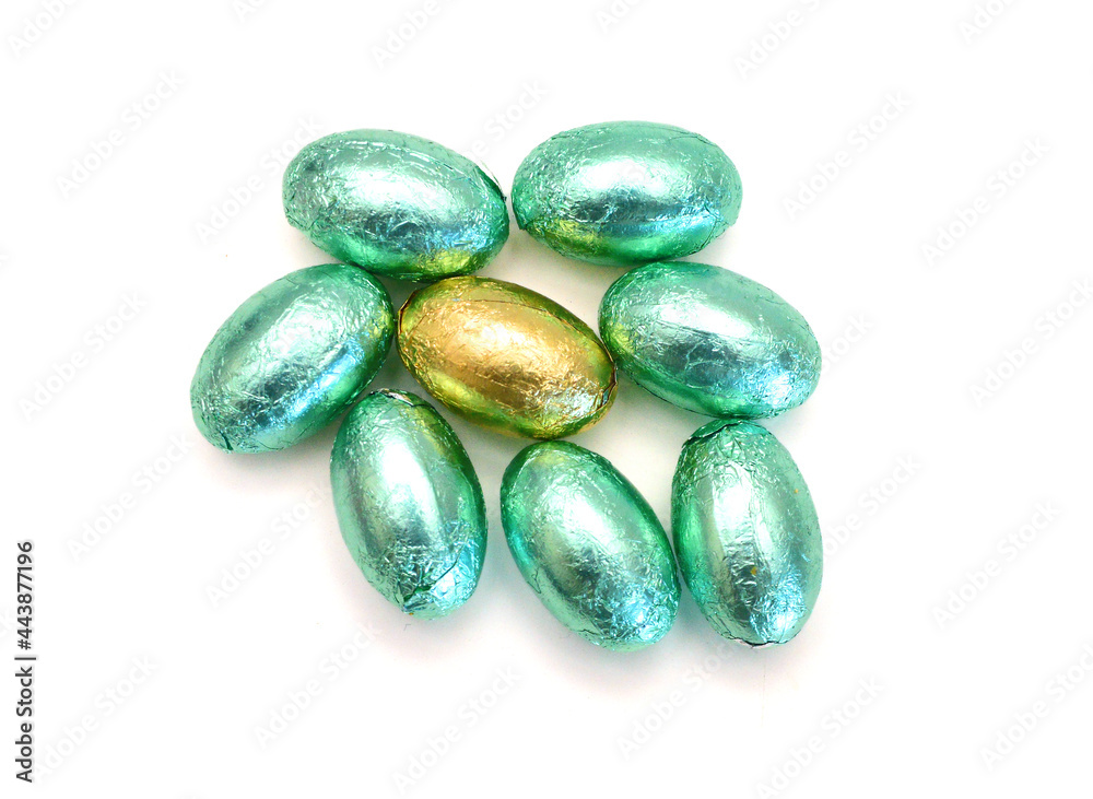 Chocolate easter eggs in colorful foil on white background Chocolate easter eggs in colorful foil on white background
